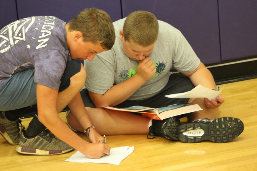 Two students work on their scavenger hunt.